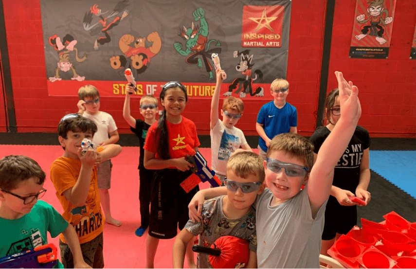 A group of children with goggles and nerf guns